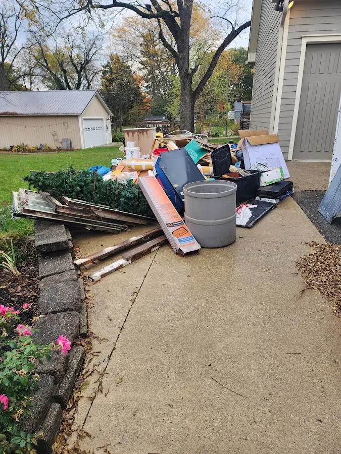 Dumpster being loaded with debris for Estate Cleanout Dumpster Rental in Seymour